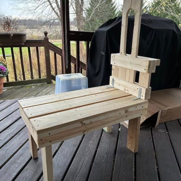 The small goat stand on a balcony.